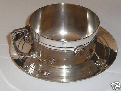 silver cup and saucer