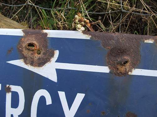 Battle damaged Road sign route to a Knights Cross.