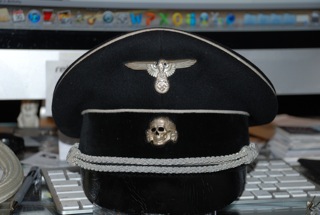 Black SS officer's cap fake: the continuation of junk by other means.
