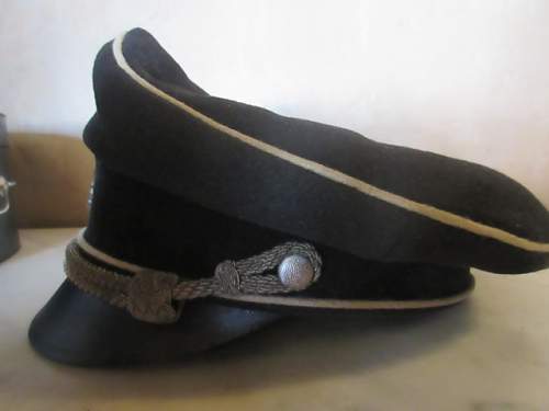 black SS officer cap, leather peak.