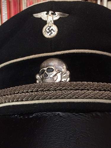 black SS officer cap, leather peak.