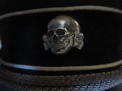 black SS officer cap, leather peak.