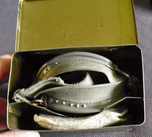 A tin of goggles with spare lens.