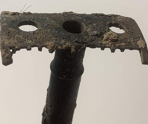 German razor with hairs from the soldier who used it still stuck in the blade area, as well as shrapnel damage