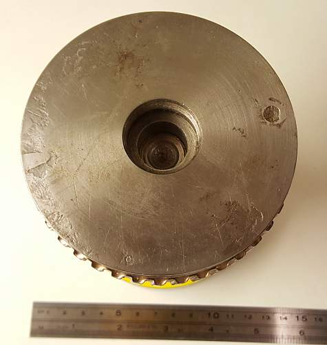 Round heavy metal thing with some melt marks on it?...