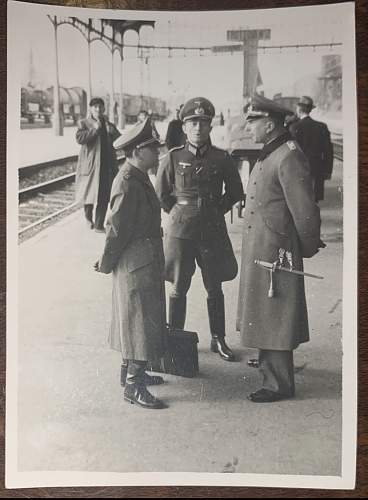 Original WW2 era photo showing what looks to be 3 German officers conversing at a train station. From my collection