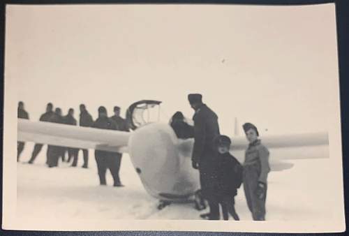 WW2 Era Photo Showing a German Soldier next to some sort of glider. Others standing nearby as well.