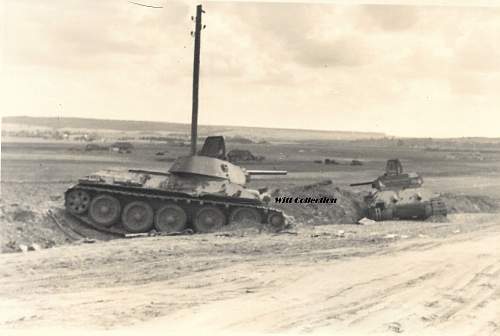 Photo of two T-34s in roadside ditch