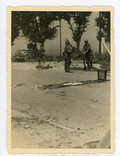 Interesting photo, German soldiers in combat, with flag on the ground.