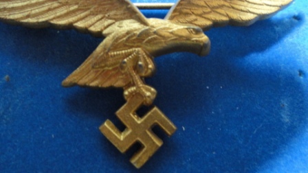 German Nazi Eagle w/ Swastika Pin (gold?) - swastika hanging from eagles claws