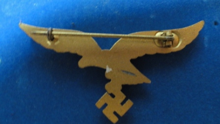 German Nazi Eagle w/ Swastika Pin (gold?) - swastika hanging from eagles claws