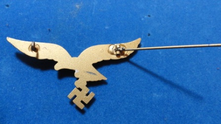 German Nazi Eagle w/ Swastika Pin (gold?) - swastika hanging from eagles claws