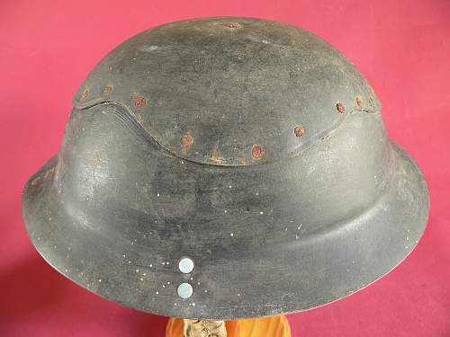 Please does anyone have any info this cardboard helmet and a non magnet steel Brodie
