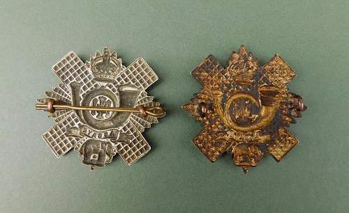 The Highland Light Infantry cap badges