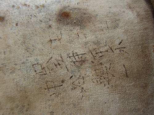 Japanese helmet, machine gun damage, japanese text inside cloth cover, translation?