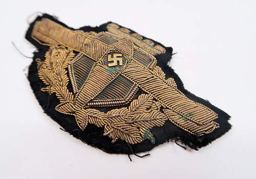 unidentified insignia - perhaps a private airline visor cap wreath &amp; swastika cockade?