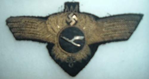 unidentified insignia - perhaps a private airline visor cap wreath &amp; swastika cockade?