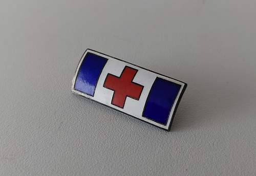 Enameled red cross pin
