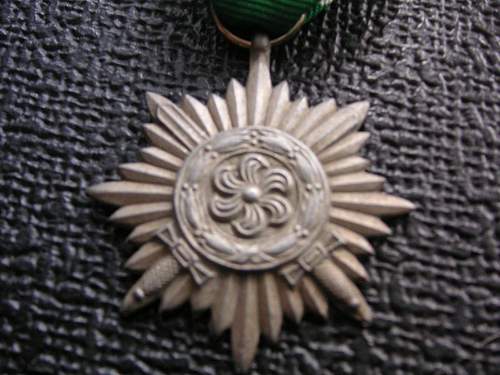 2nd class ostvolk in bronze with swords (flat reverse and no rope around the flower). wartime,57 or just a repro?