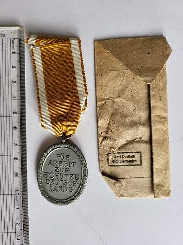 Advice on whether items are real or fake and in what case what an item is (Black Wound Badge, West Wall Medal, Kriegsverdienst Medal)