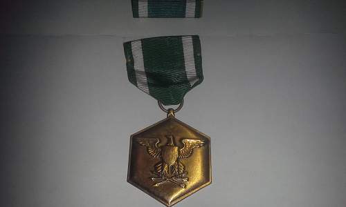 A slot brooch Navy Commendation Medal.