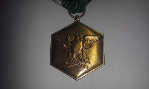 A slot brooch Navy Commendation Medal.