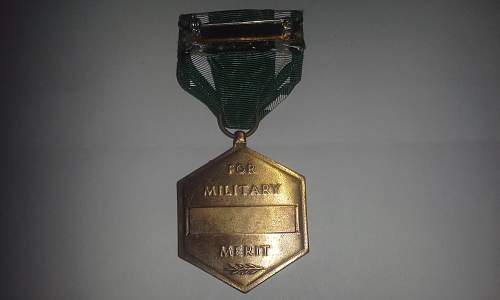 A slot brooch Navy Commendation Medal.