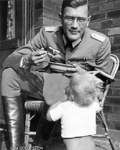 Photo of german father feeding his child