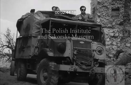 Need your help for identify soldier on photo (inside truck)