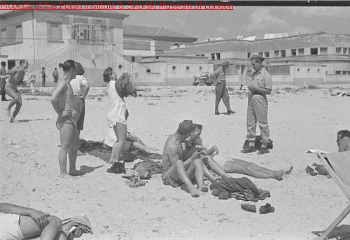 Need your help for identify soldier on photo (inside truck)