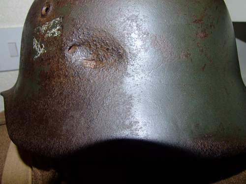 battle-damaged SD M40 helmet