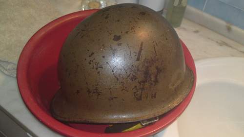 The cleaning of an M1C helmet