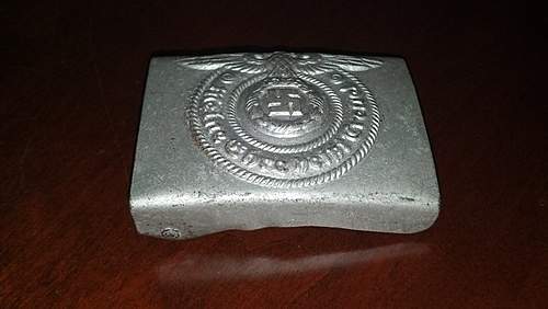Have an SS Belt Buckle, Aluminum. Marked Well but I've had it in my repro pile for 2 years. Want to get a second opinion!