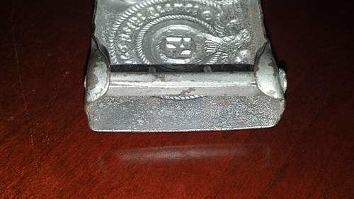 Have an SS Belt Buckle, Aluminum. Marked Well but I've had it in my repro pile for 2 years. Want to get a second opinion!