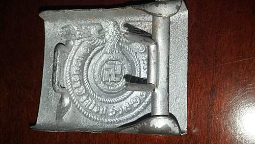 Have an SS Belt Buckle, Aluminum. Marked Well but I've had it in my repro pile for 2 years. Want to get a second opinion!