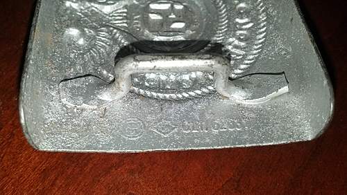 Have an SS Belt Buckle, Aluminum. Marked Well but I've had it in my repro pile for 2 years. Want to get a second opinion!