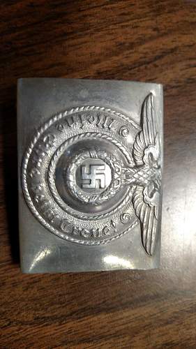 Have an SS Belt Buckle, Aluminum. Marked Well but I've had it in my repro pile for 2 years. Want to get a second opinion!