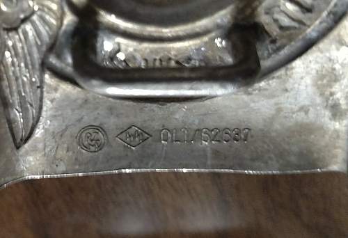 Have an SS Belt Buckle, Aluminum. Marked Well but I've had it in my repro pile for 2 years. Want to get a second opinion!