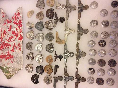 Large collection of SS metal insignia and buckles in dug / battlefield condition
