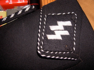 SS market in total rout:  black SS officer's cap sells for almost nothing in auction.