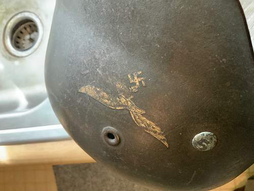 LW Helmet with apparent bullet/shrapnel hit