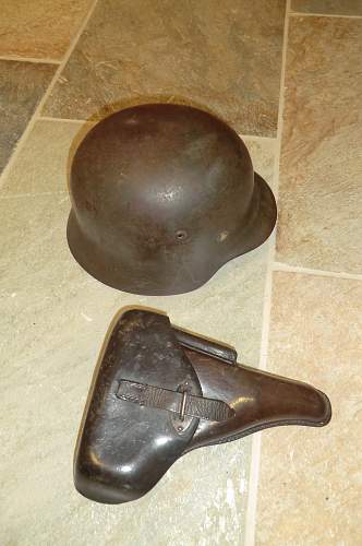 Army helmet and pistol belonging to the same soldier.