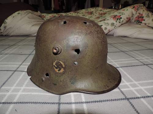 WW1 battle damaged German helmet with WW2 Nazi decals