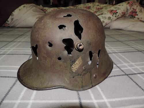 WW1 battle damaged German helmet with WW2 Nazi decals