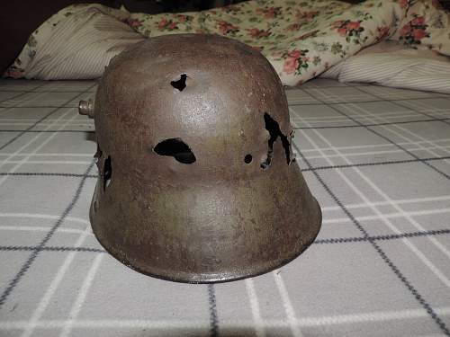WW1 battle damaged German helmet with WW2 Nazi decals