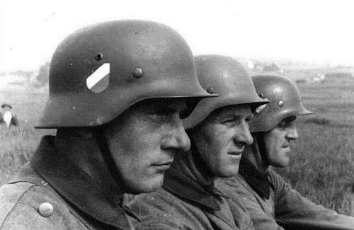 Nice period shot of 3 M35 Heer double decal helmets in use....