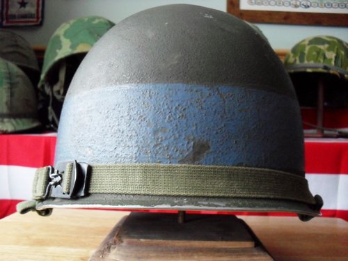 Fixed bail M-1 helmet, looks to have a gray painted band ?