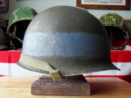 Fixed bail M-1 helmet, looks to have a gray painted band ?