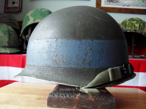 Fixed bail M-1 helmet, looks to have a gray painted band ?