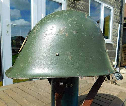 Romanian M73/80 steel helmet with parade badge.